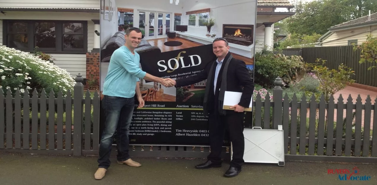 Client and property manager standing in front of a sold investment property in Melbourne.