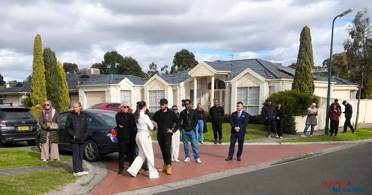 Prospective buyers gathered outside a Melbourne home during a property auction.